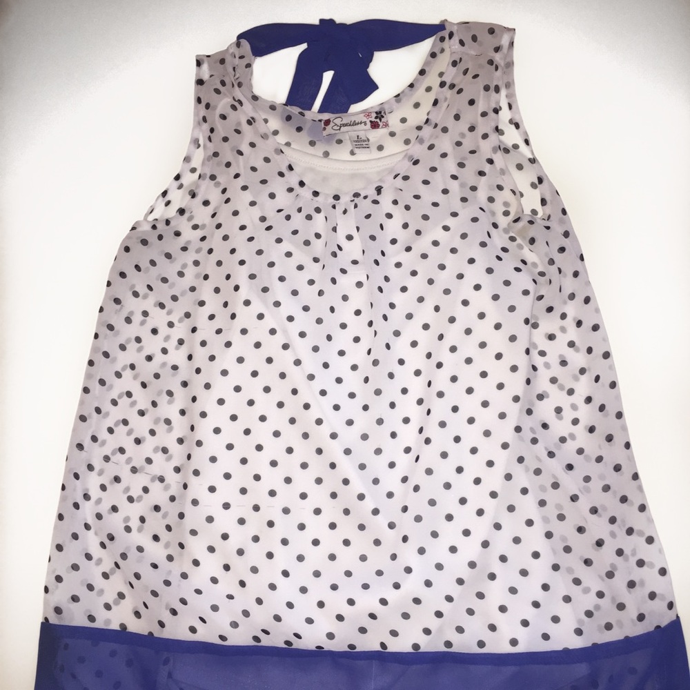 White blouse with polka dots, blue bow and trim.